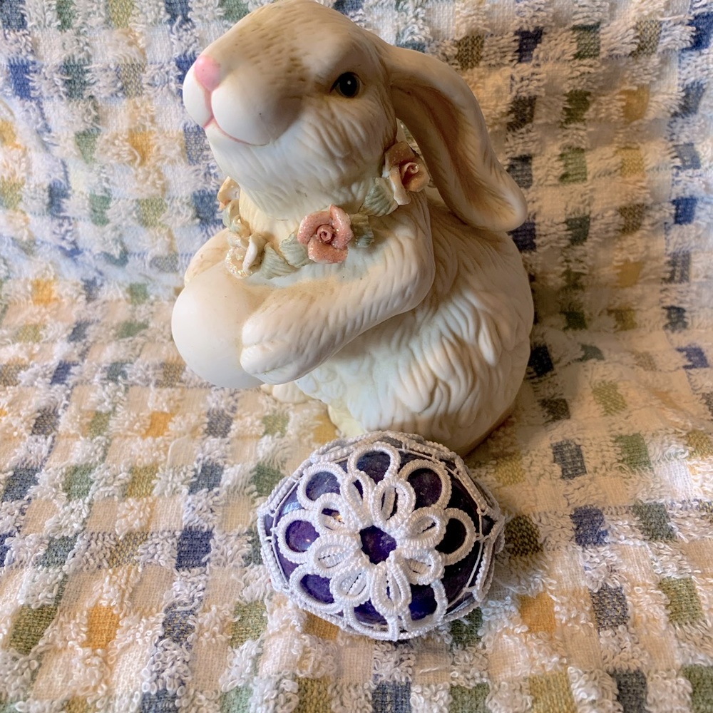Polished stone egg with tatted cover and egg cup for display